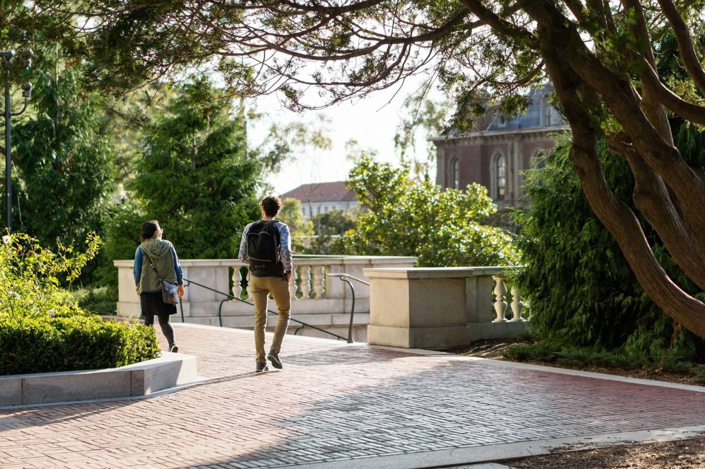 A student walking across a college campus